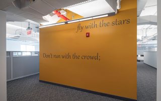Wall with quote: Don't run with the crowd, fly with the stars