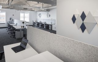 Office interior design with adjustable height desks and acoustic panels on walls