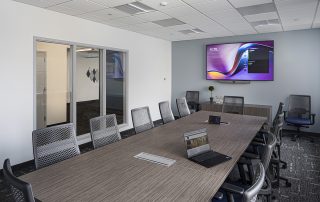 Conference Room with table, chairs and monitor on wall