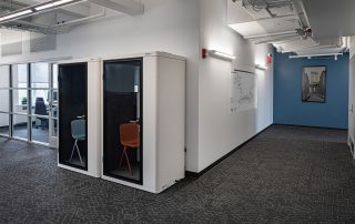 Corporate office hallway with privacy phone booths